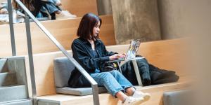 A student working on their laptop in qʷta:yθən leləm̓ (Sturgeon House)